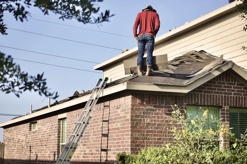Professional roofer working on a residential roof in Canyon